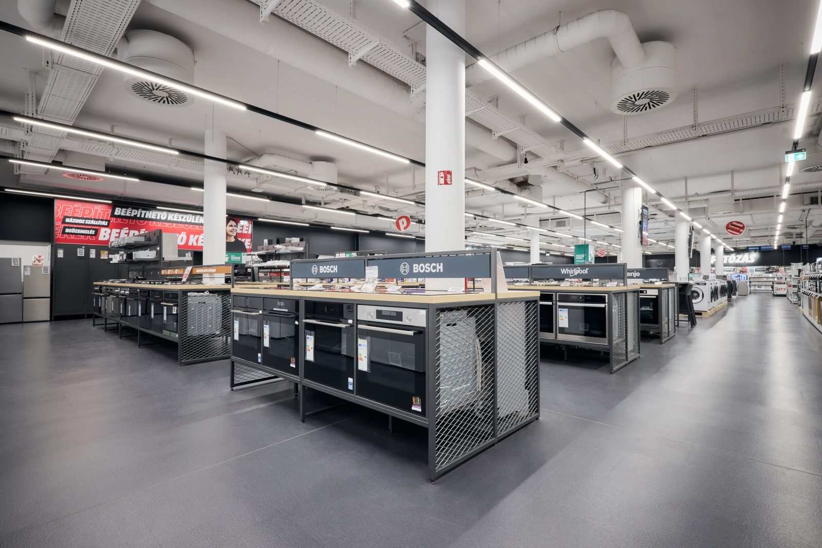 Modern kitchen appliances section at Megaholz store with Bosch and Whirlpool brands.