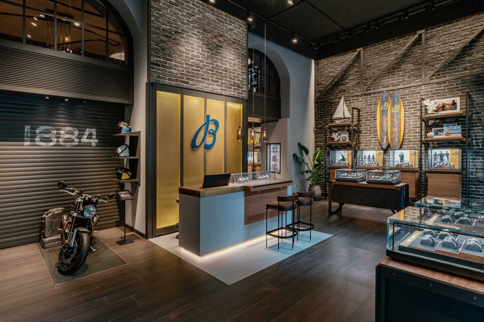 Modern luxury watch store interior with brick walls and motorcycle display.