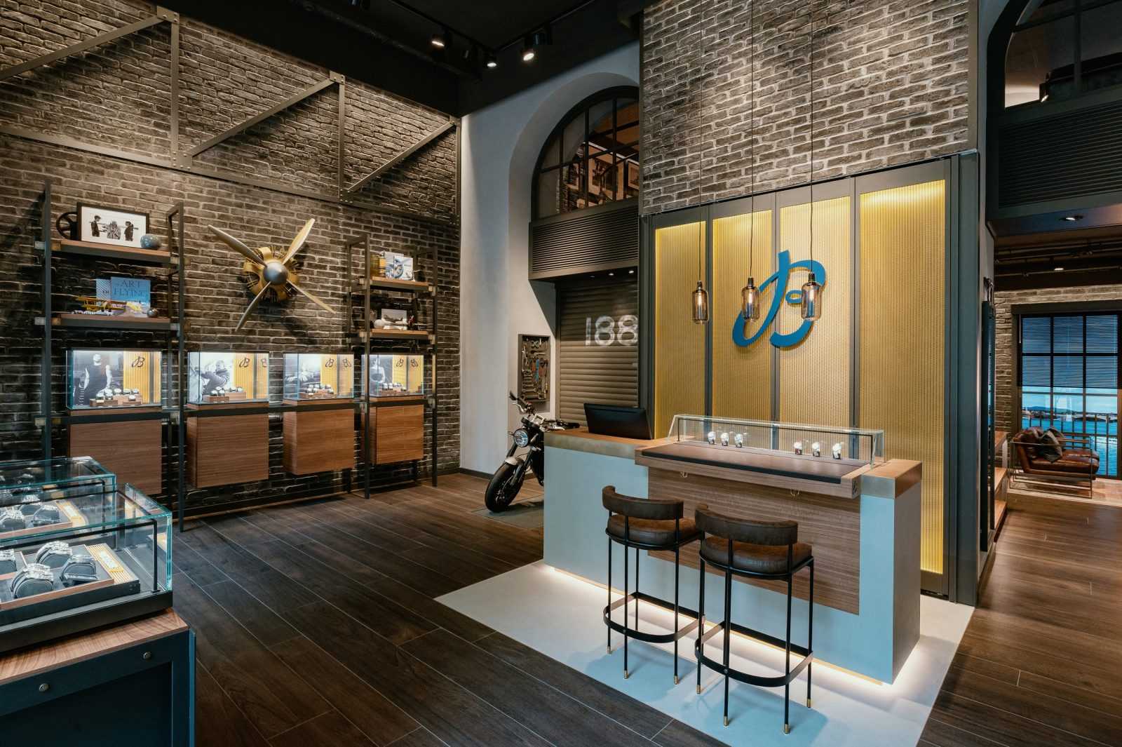 Modern luxury watch store interior with brick walls and display cases.