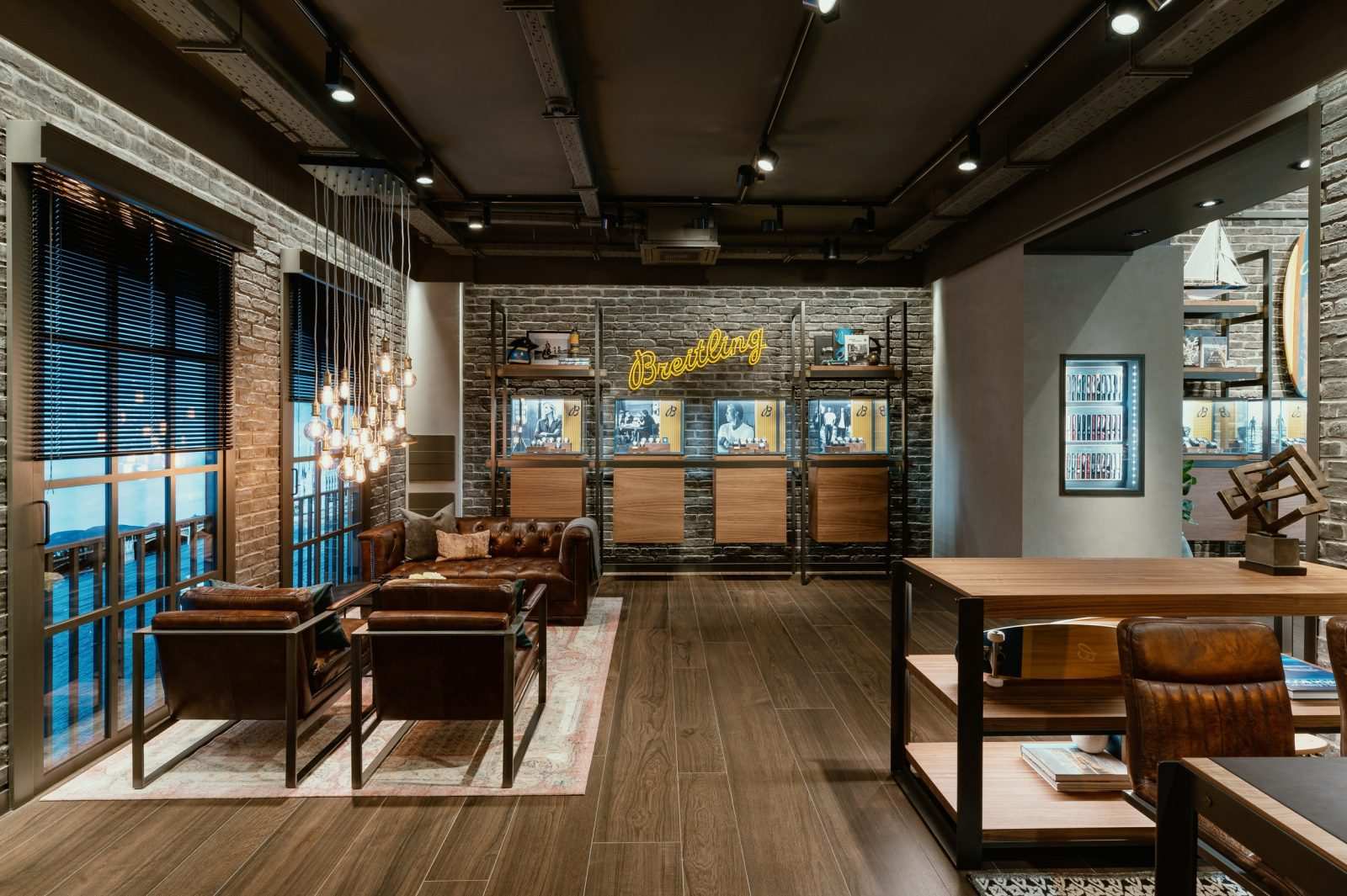 Luxury Breitling watch store interior with leather furniture and brick walls.