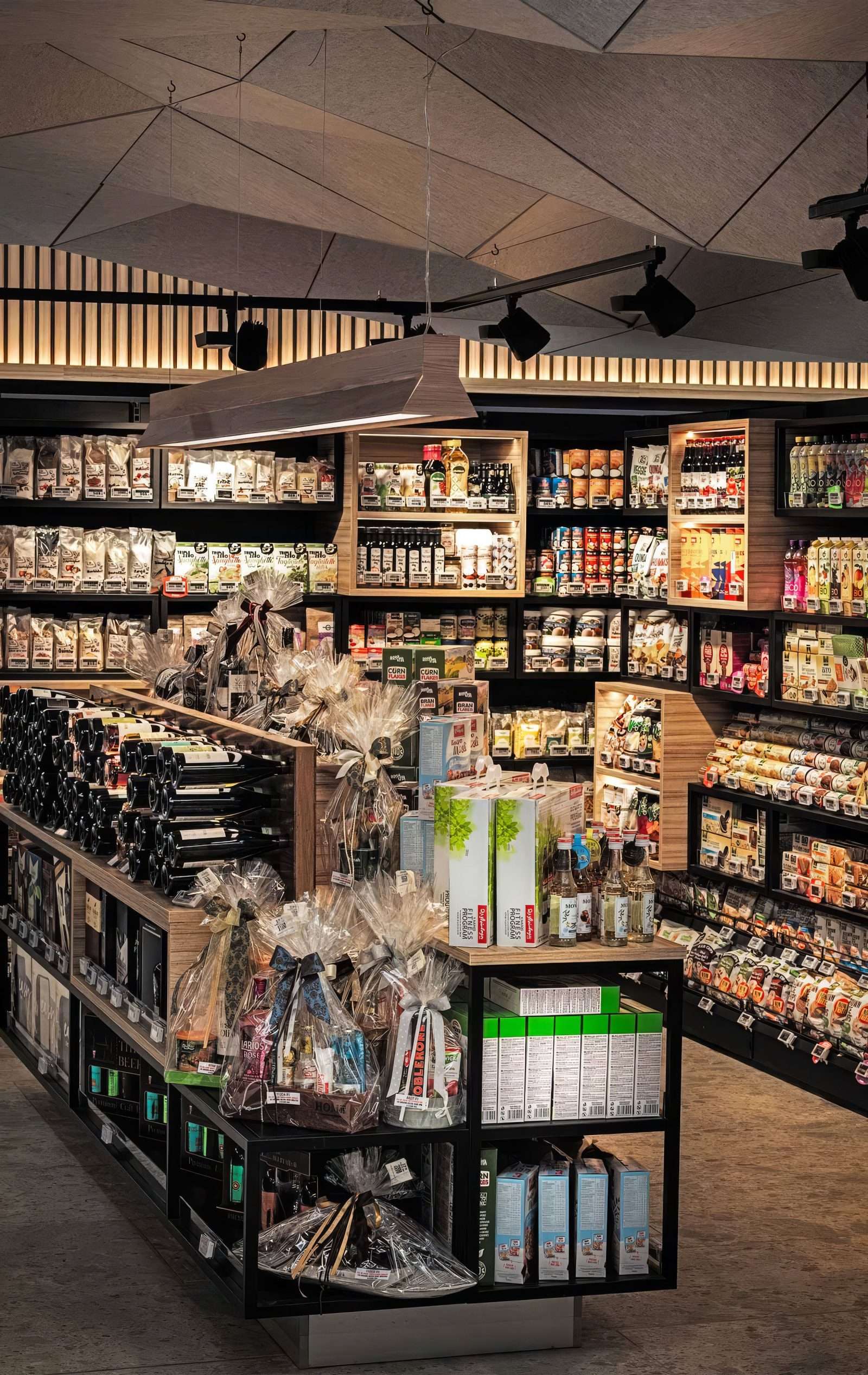 Modern grocery store interior with shelves of gourmet food and wine.