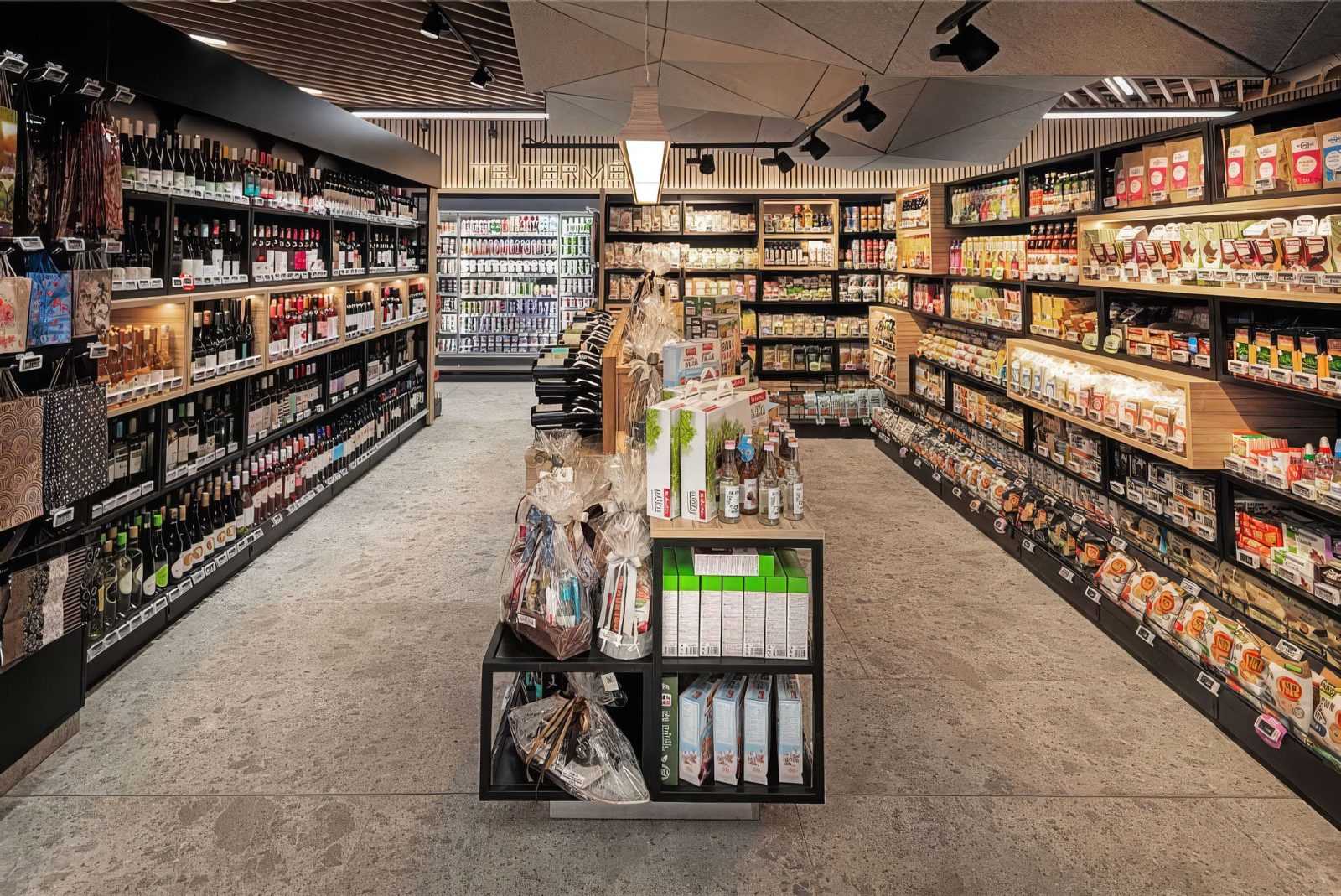 Modern grocery store interior with well-stocked shelves and gourmet products.