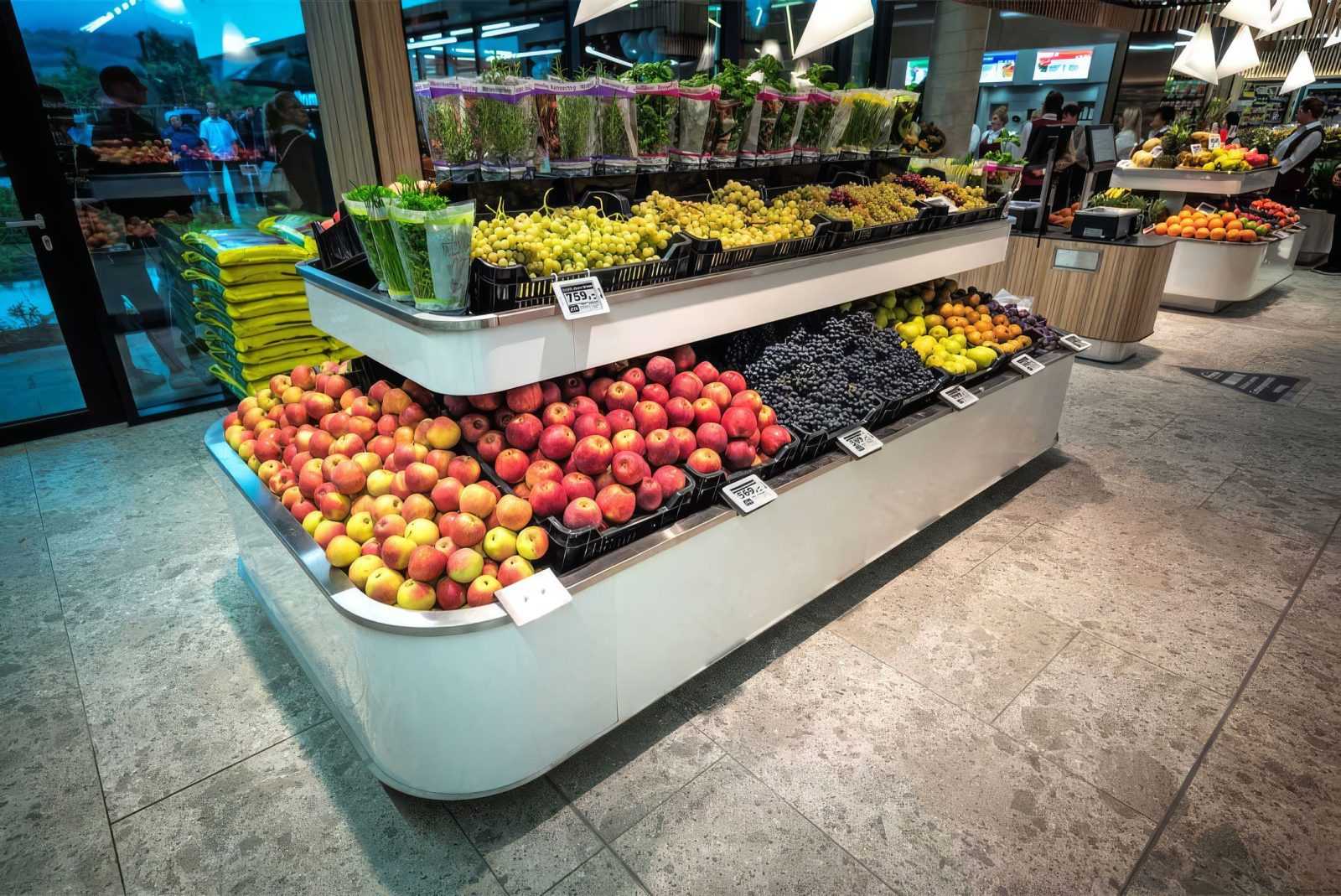 Fresh fruits and vegetables display in modern supermarket.