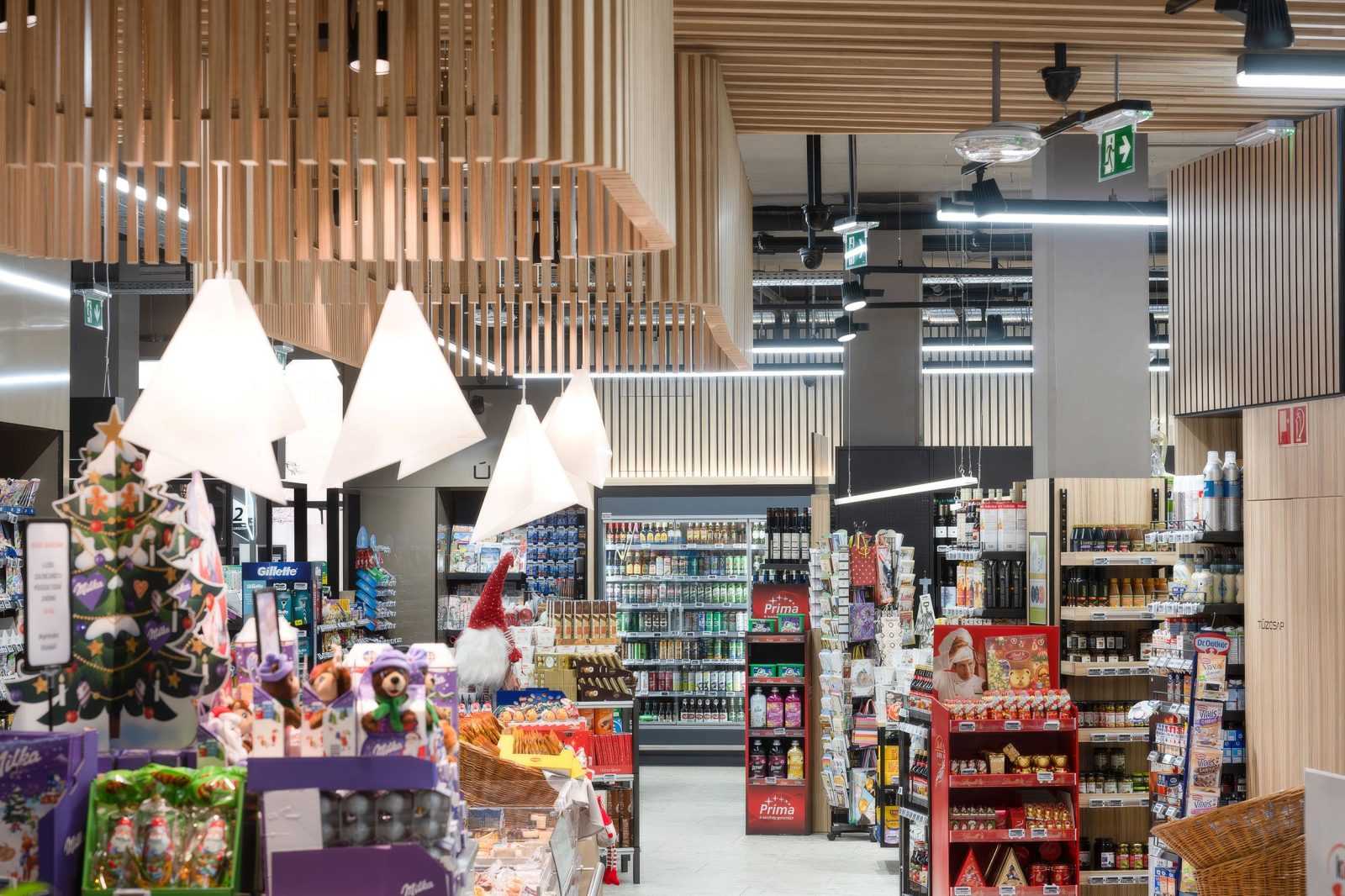 Modern supermarket interior with wooden ceiling design and festive Christmas decorations.