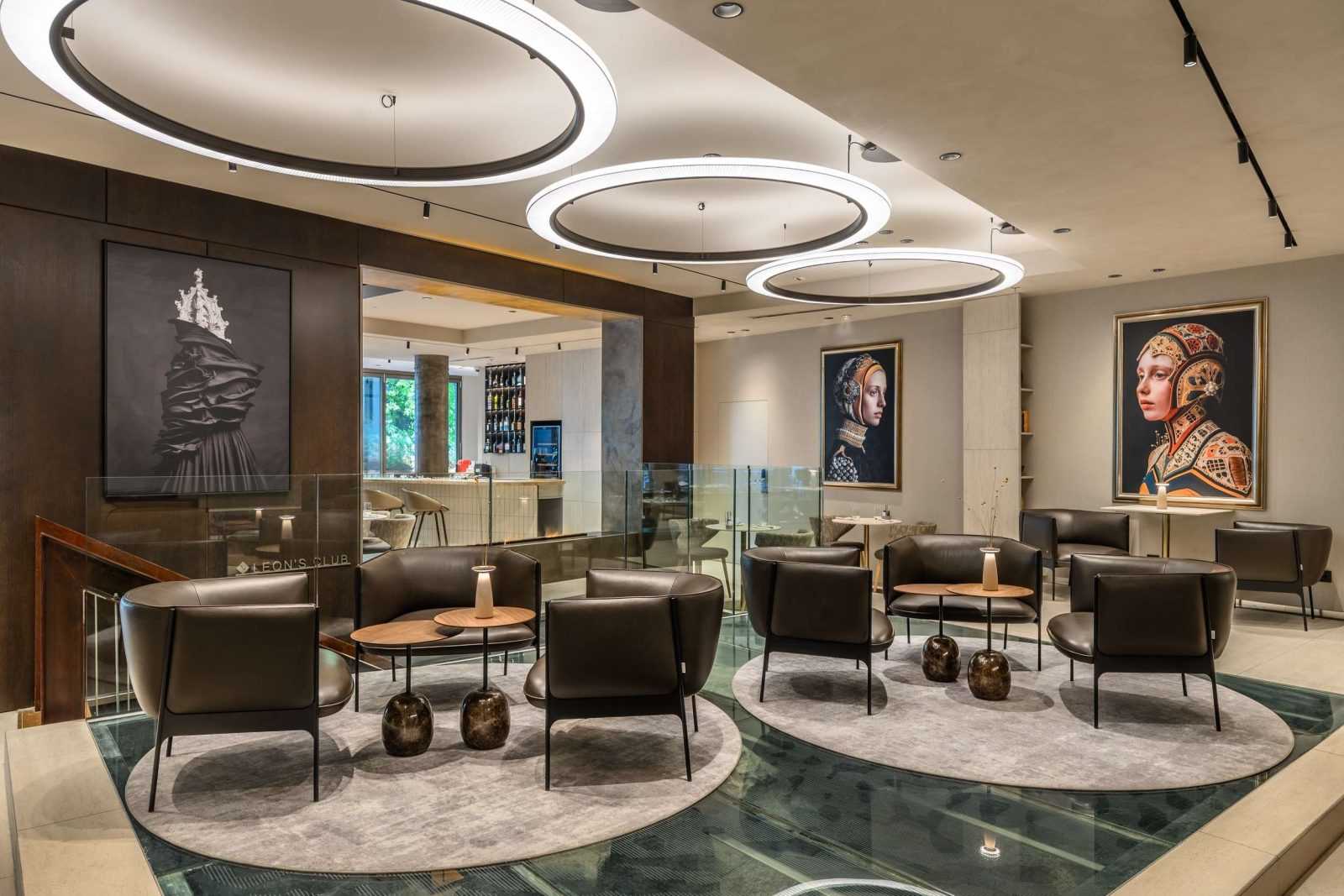 Modern luxury lounge with circular lighting and contemporary art.