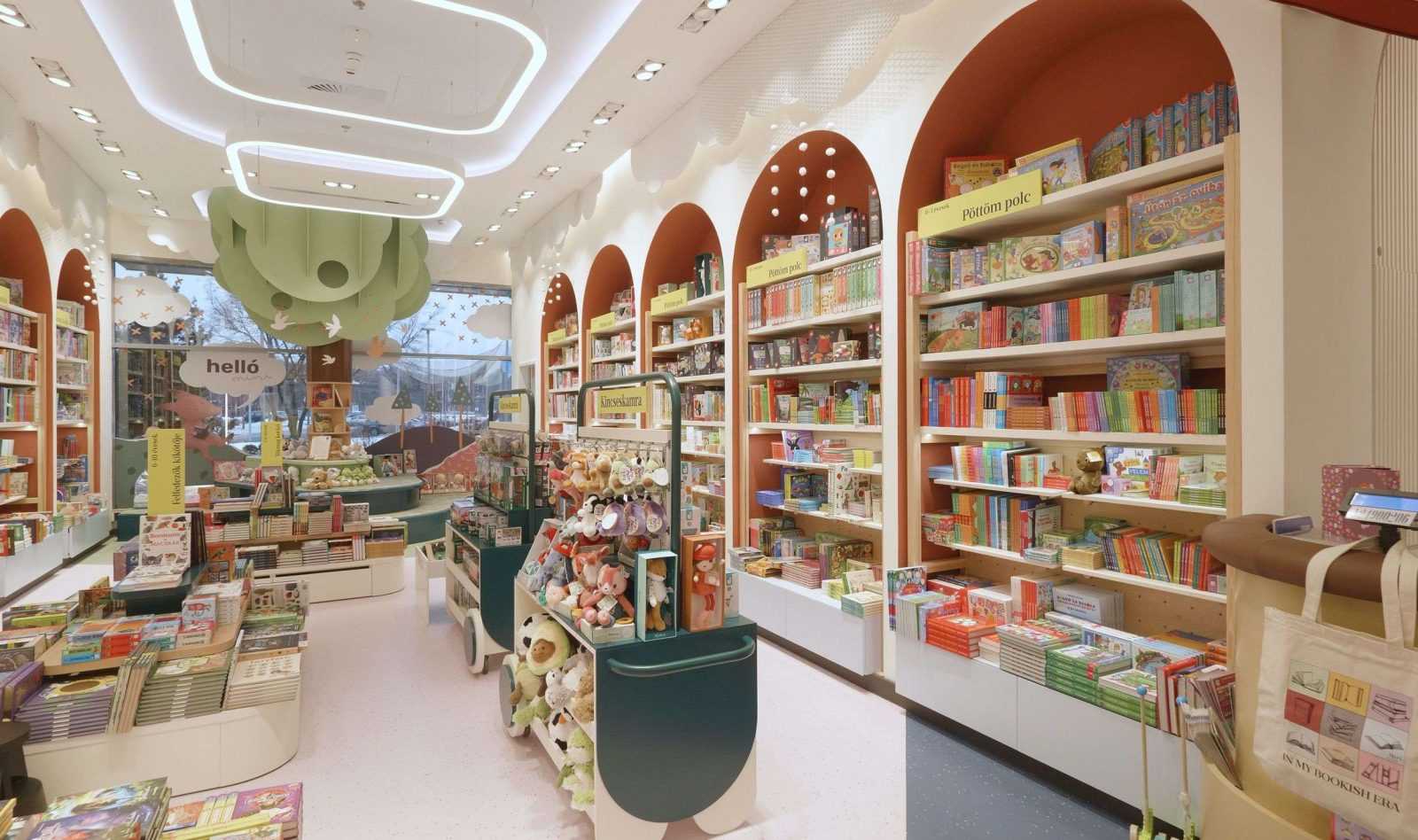 Colorful children's bookstore with arched bookshelves and plush toys.