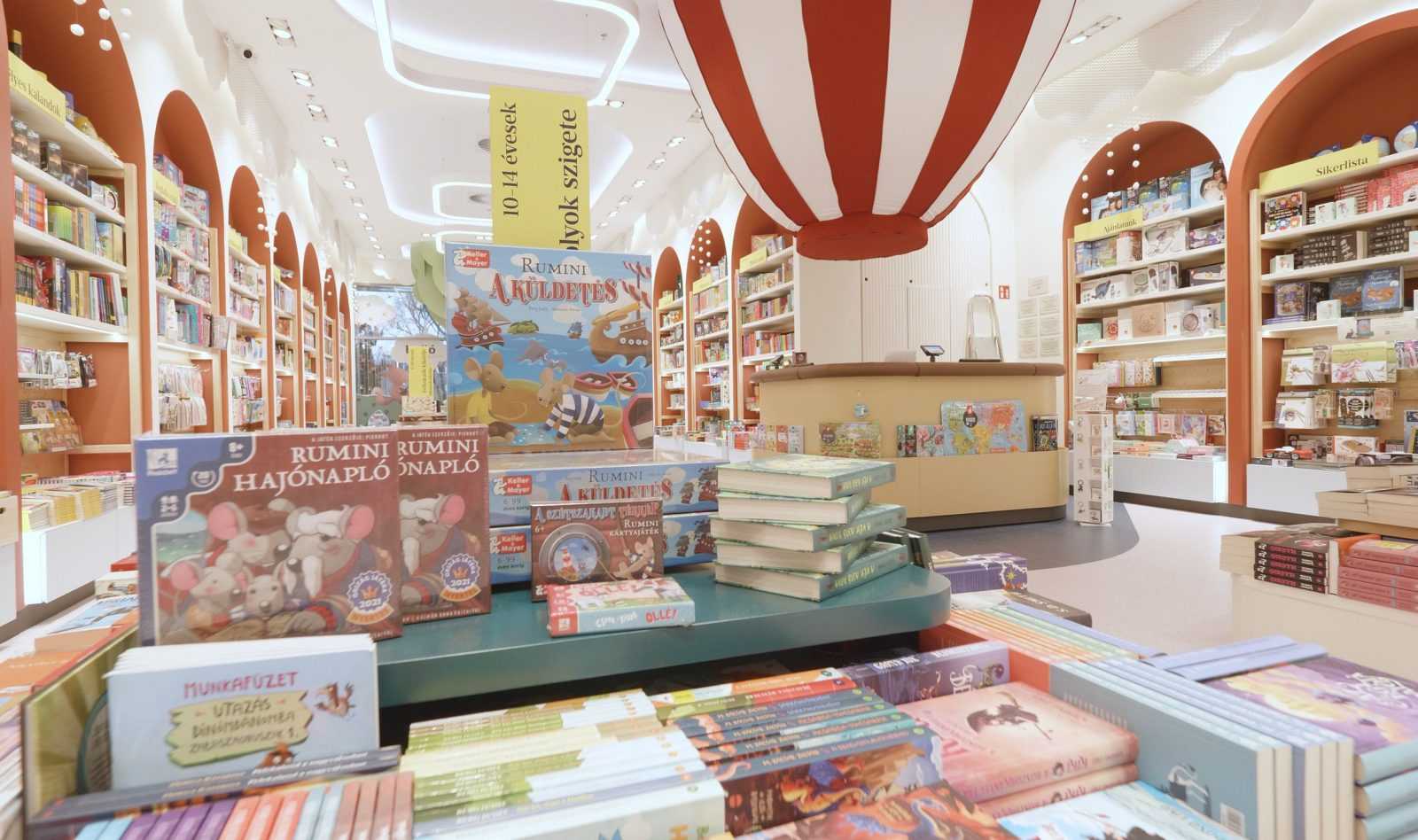 Megaholz children's bookstore interior with colorful bookshelves and hot air balloon decoration.