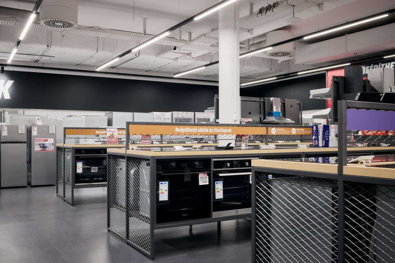 Modern kitchen appliances section at Megaholz store with ovens and refrigerators.