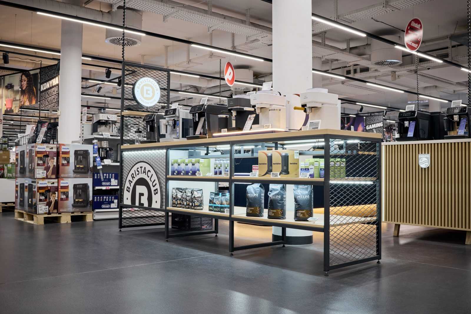 Modern coffee shop section in Megaholz store with espresso machines and coffee beans.