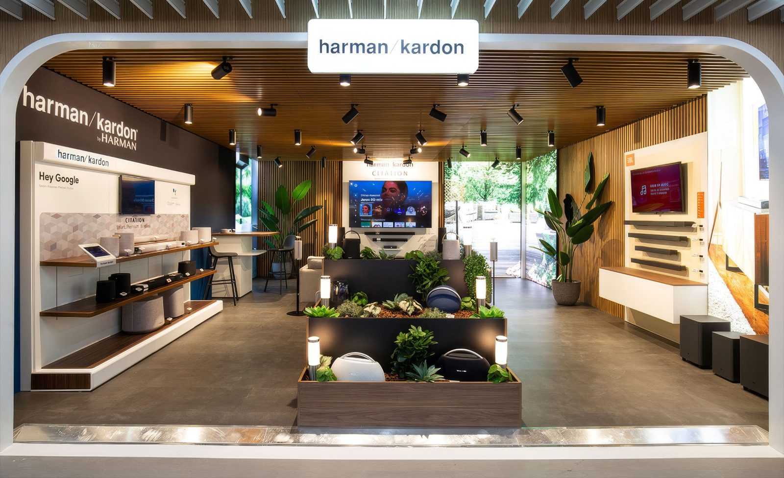Harman Kardon audio showroom with modern wooden design and product displays.