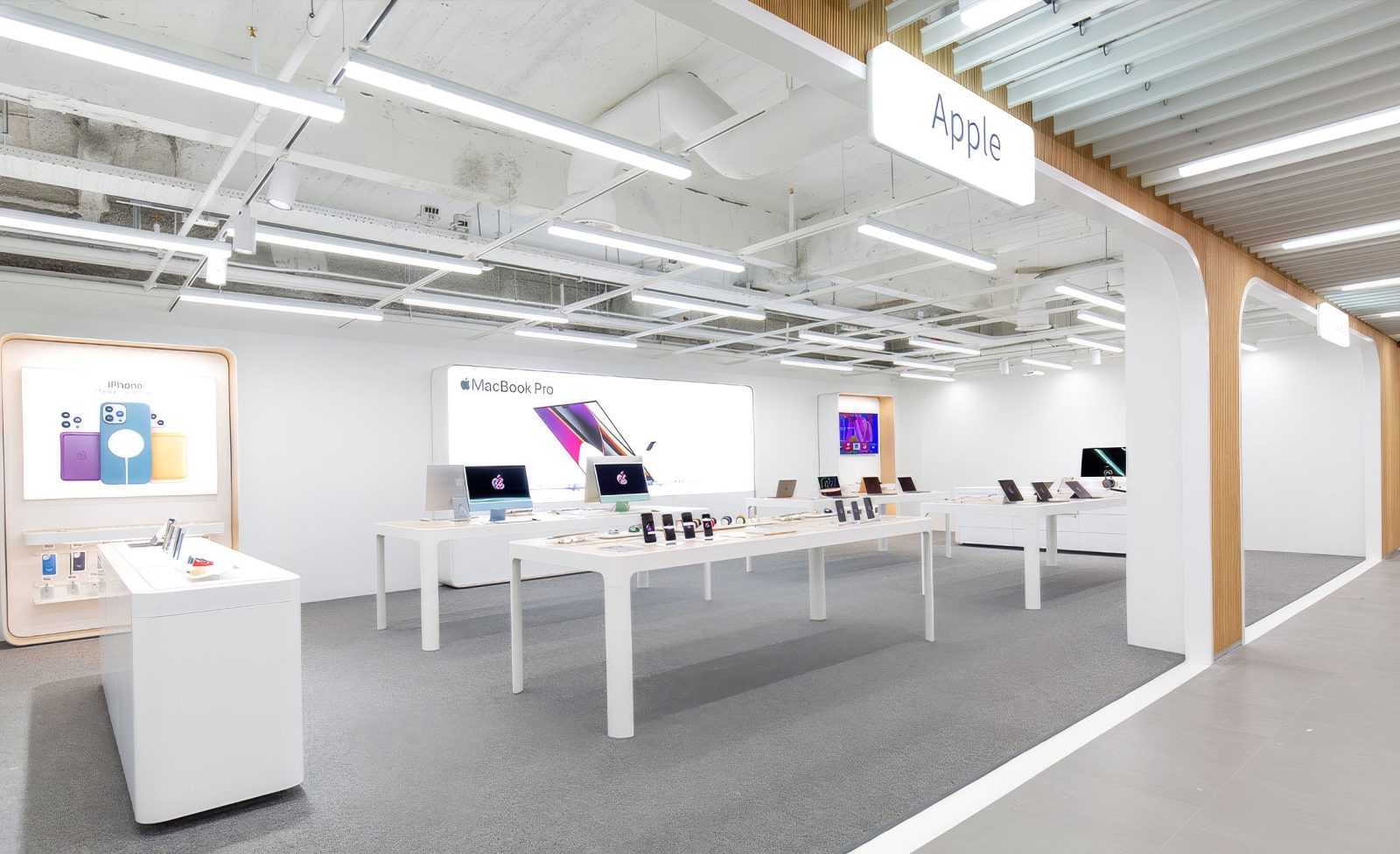 Apple Store interior showcasing iPhone and MacBook Pro displays.