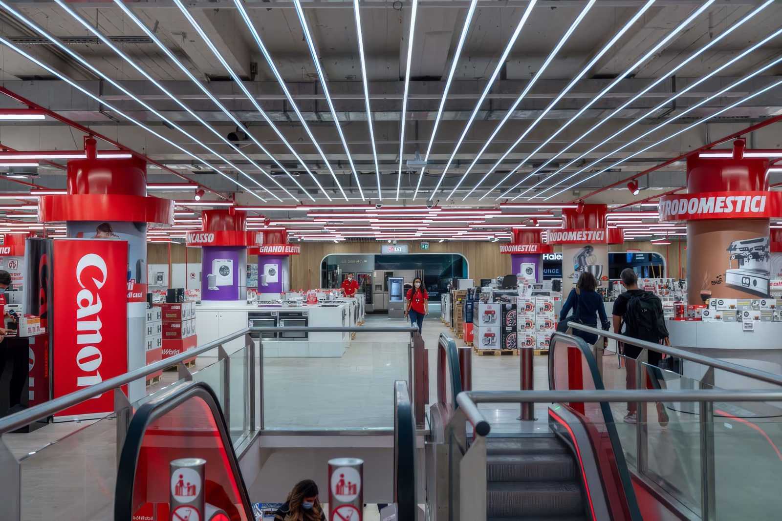 Interior of Megaholz store with escalators and Canon display.