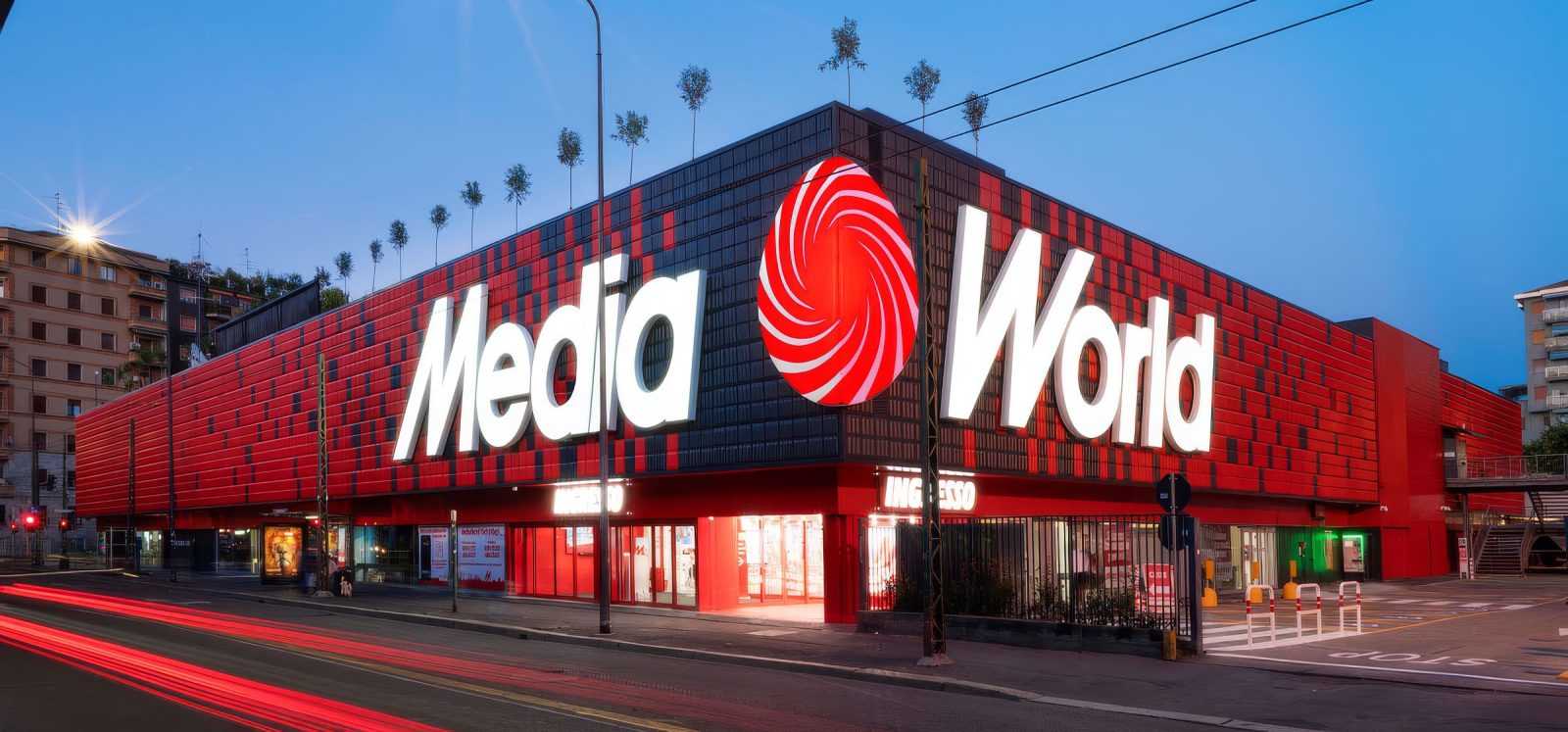 Media World store exterior at dusk with red and black facade.