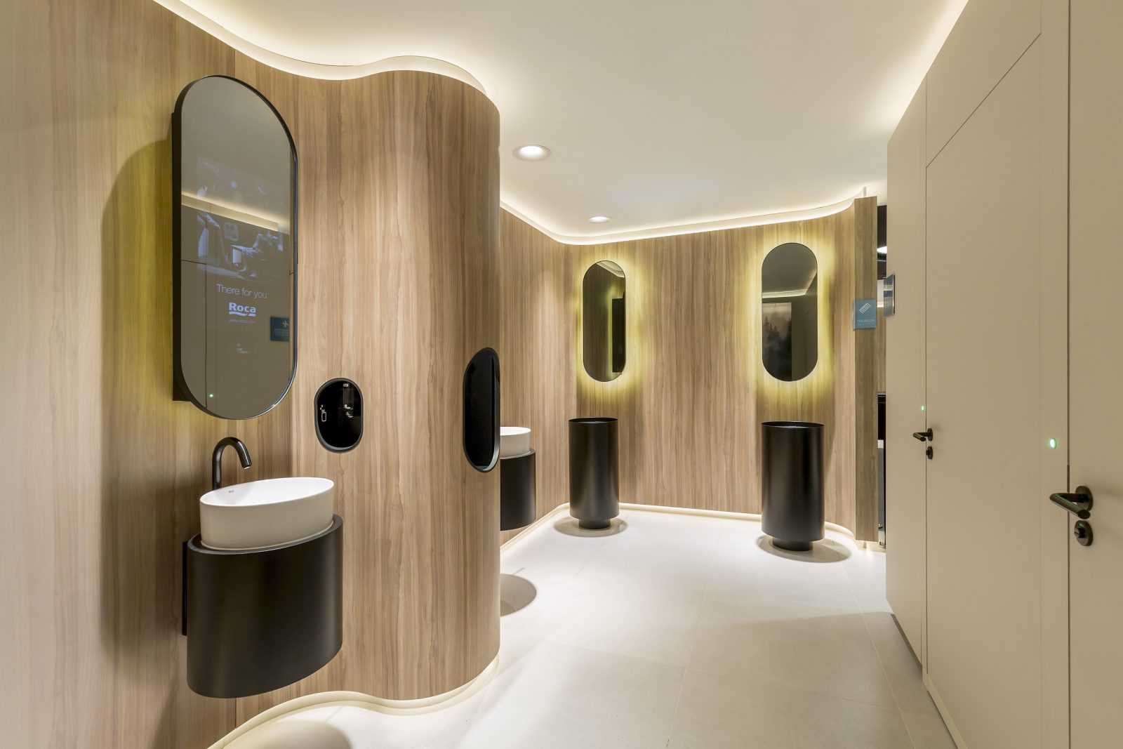 Modern wooden bathroom with sleek black fixtures and ambient lighting.