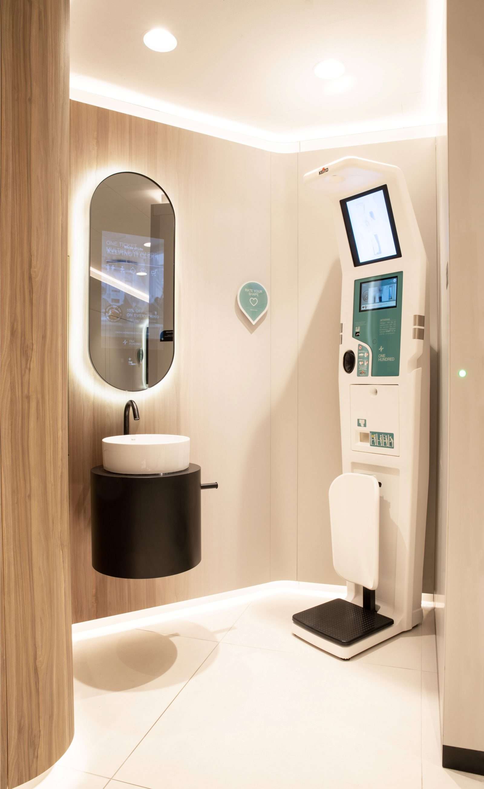 Modern smart body scan kiosk with sink in sleek wellness room.