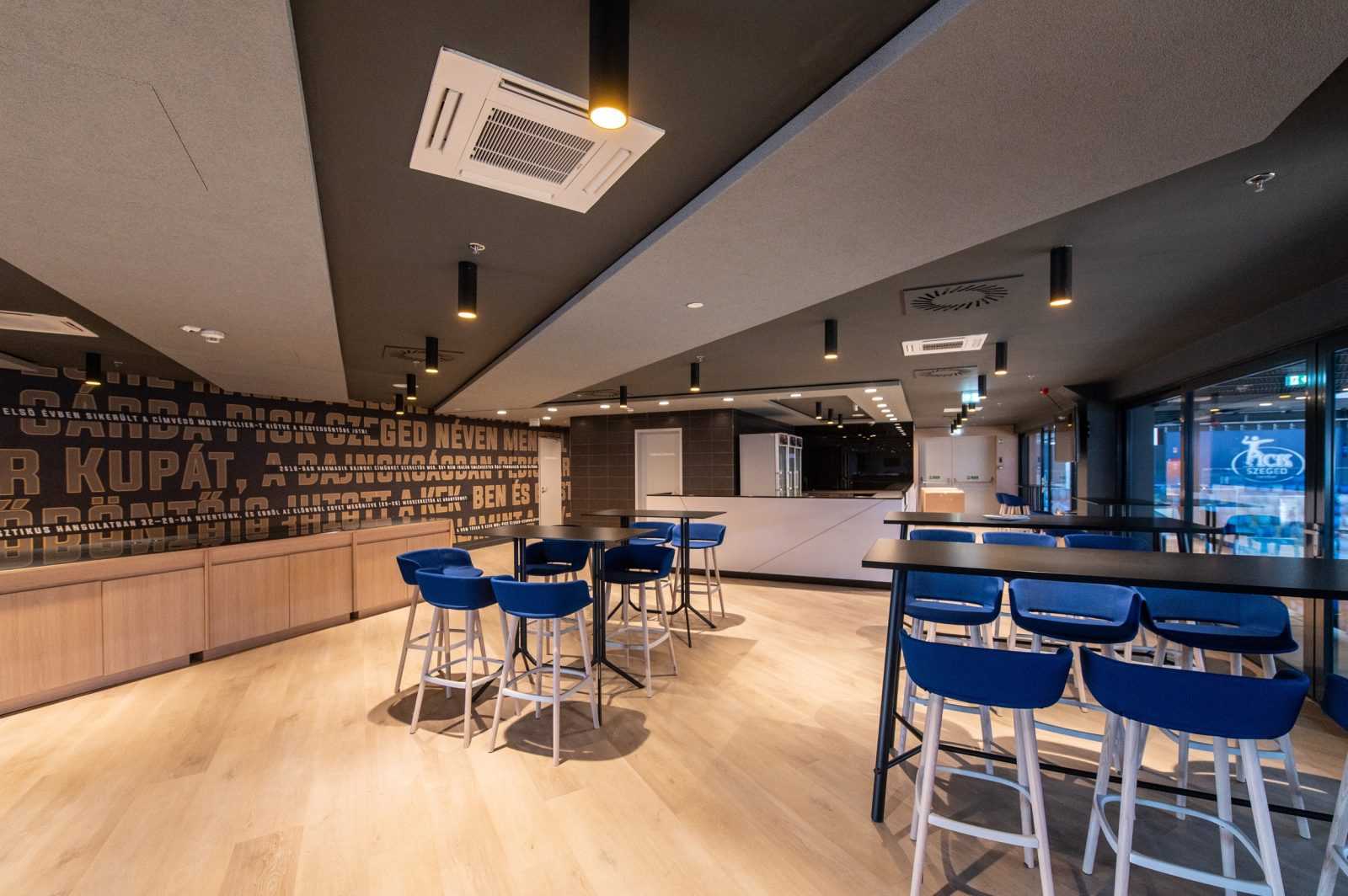 Modern bar interior with blue stools and wooden floors at Megaholz.