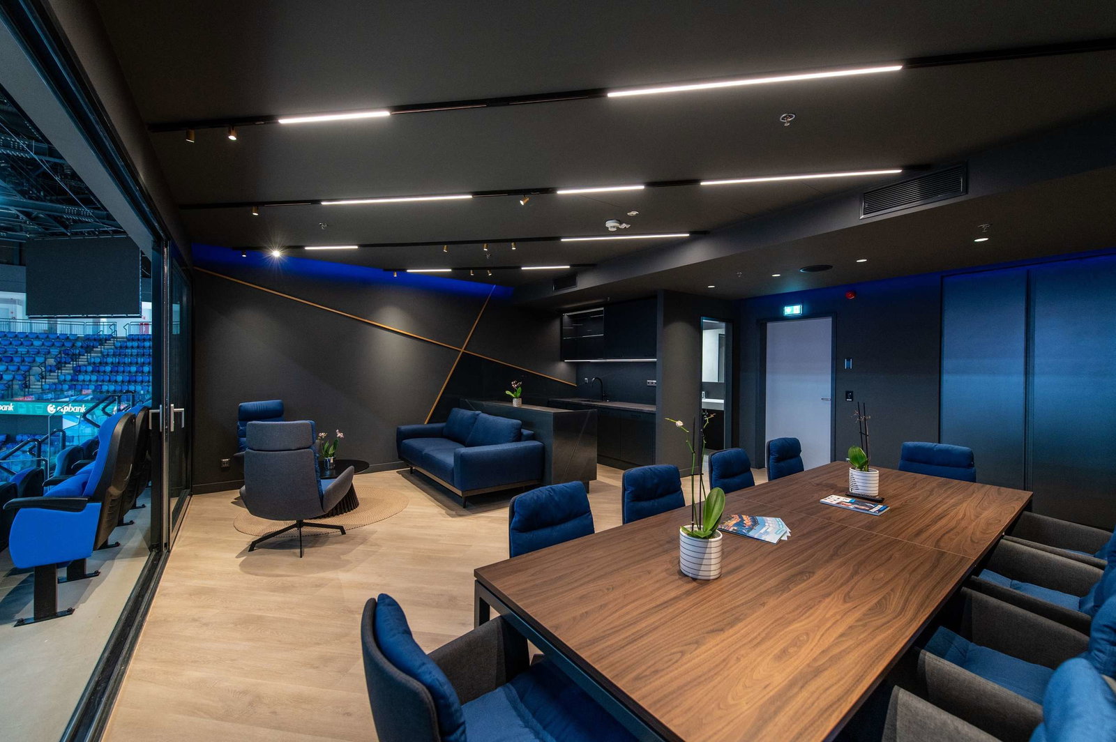 Modern luxury lounge with blue seating and wooden table at Megaholz.