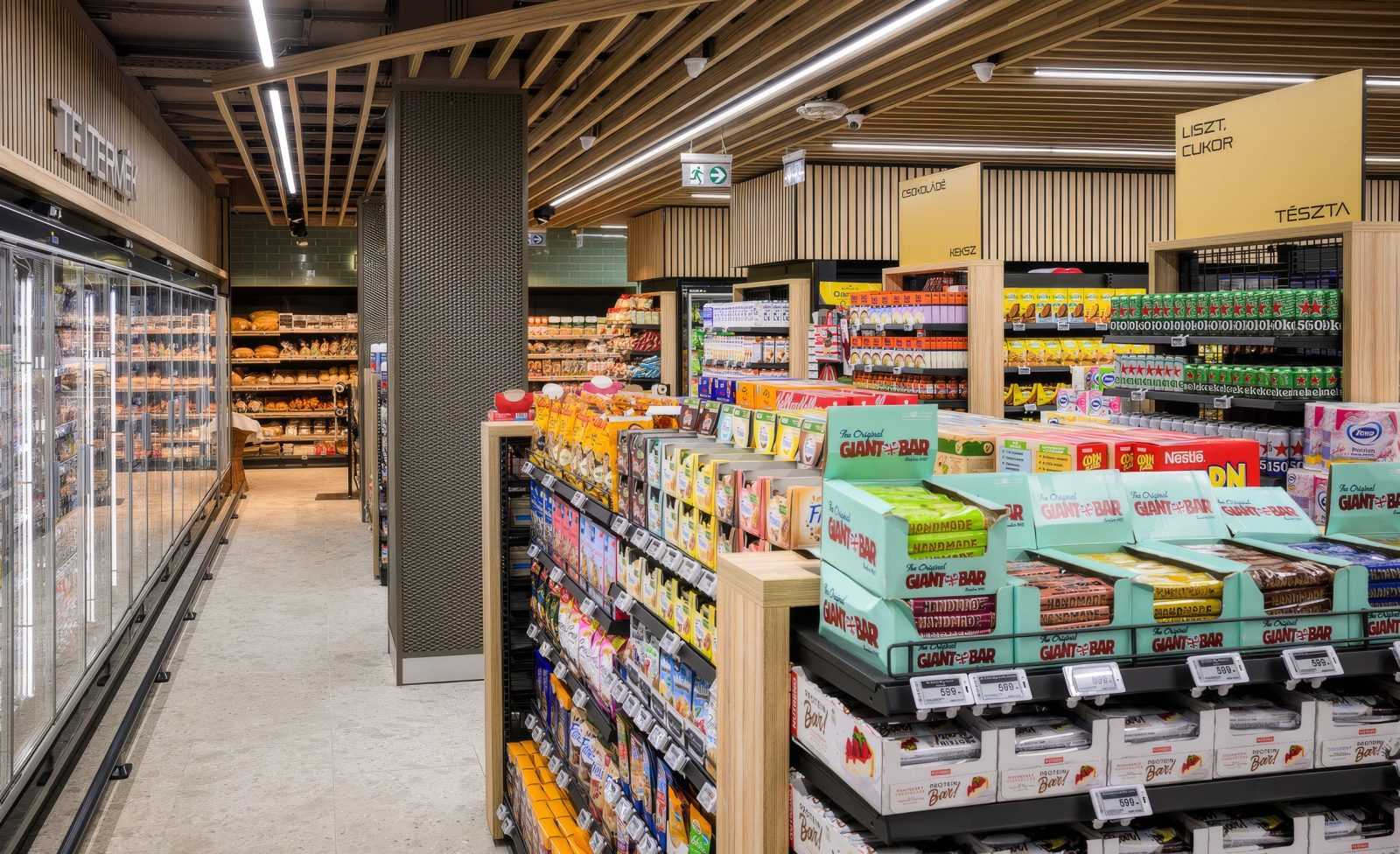 Modern Megaholz supermarket interior with snack aisles and bakery section.