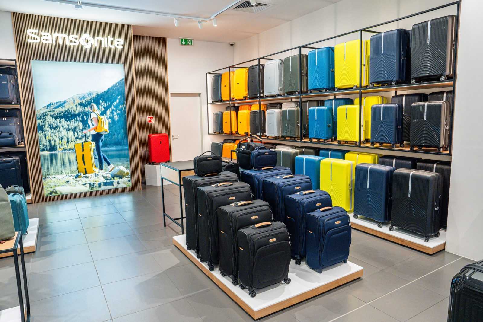 Samsonite luggage store interior with colorful suitcases on display.