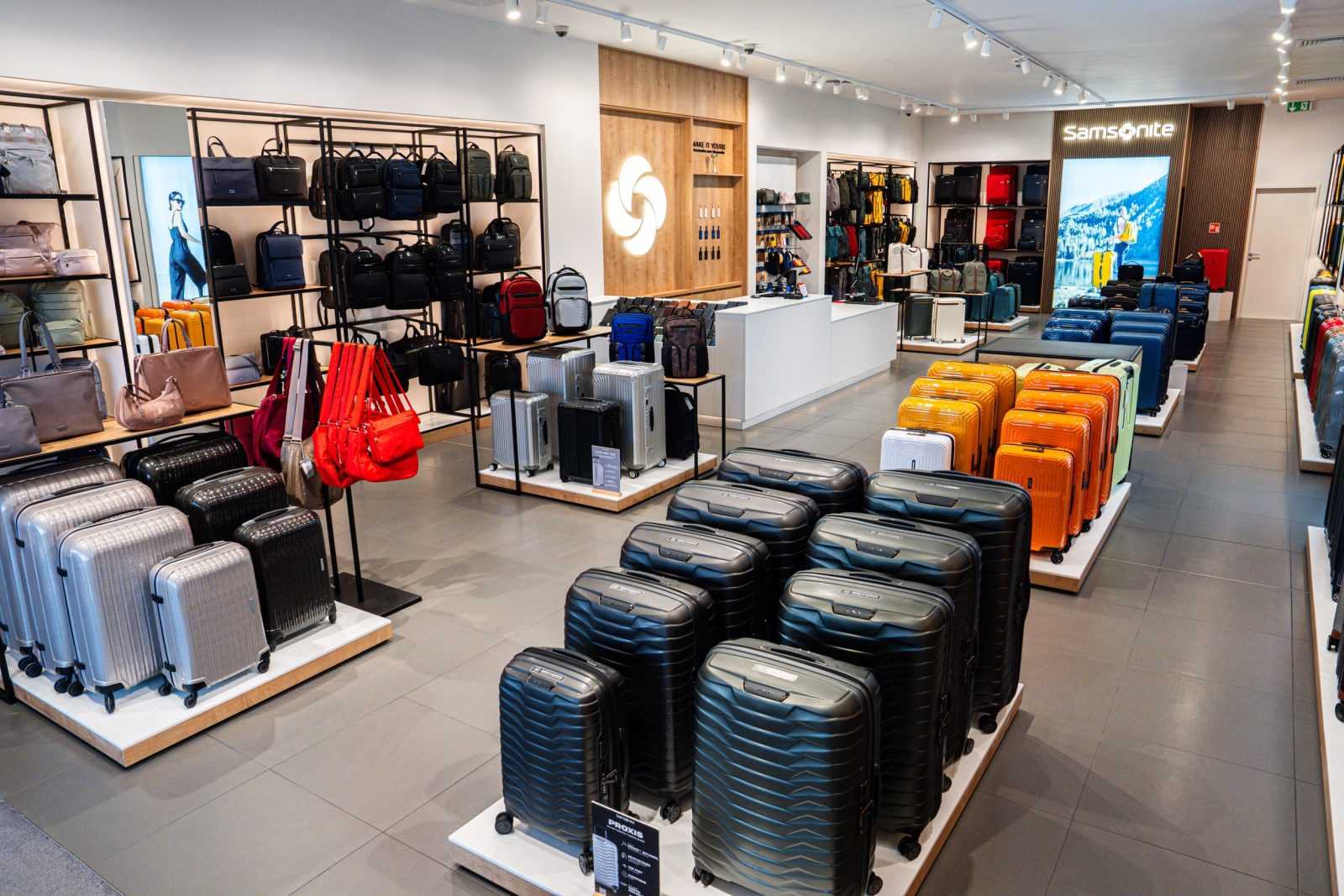 Samsonite luggage store interior with colorful suitcases and backpacks.
