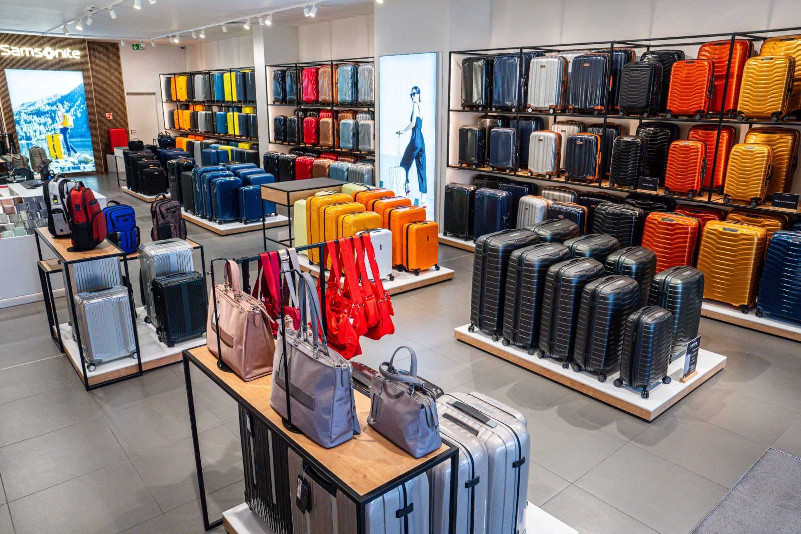 Samsonite luggage store interior with colorful suitcases and handbags.