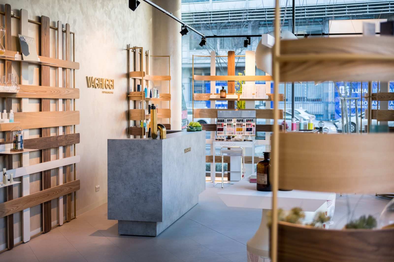 Modern Vagheggi store interior with wooden shelves and concrete counter.