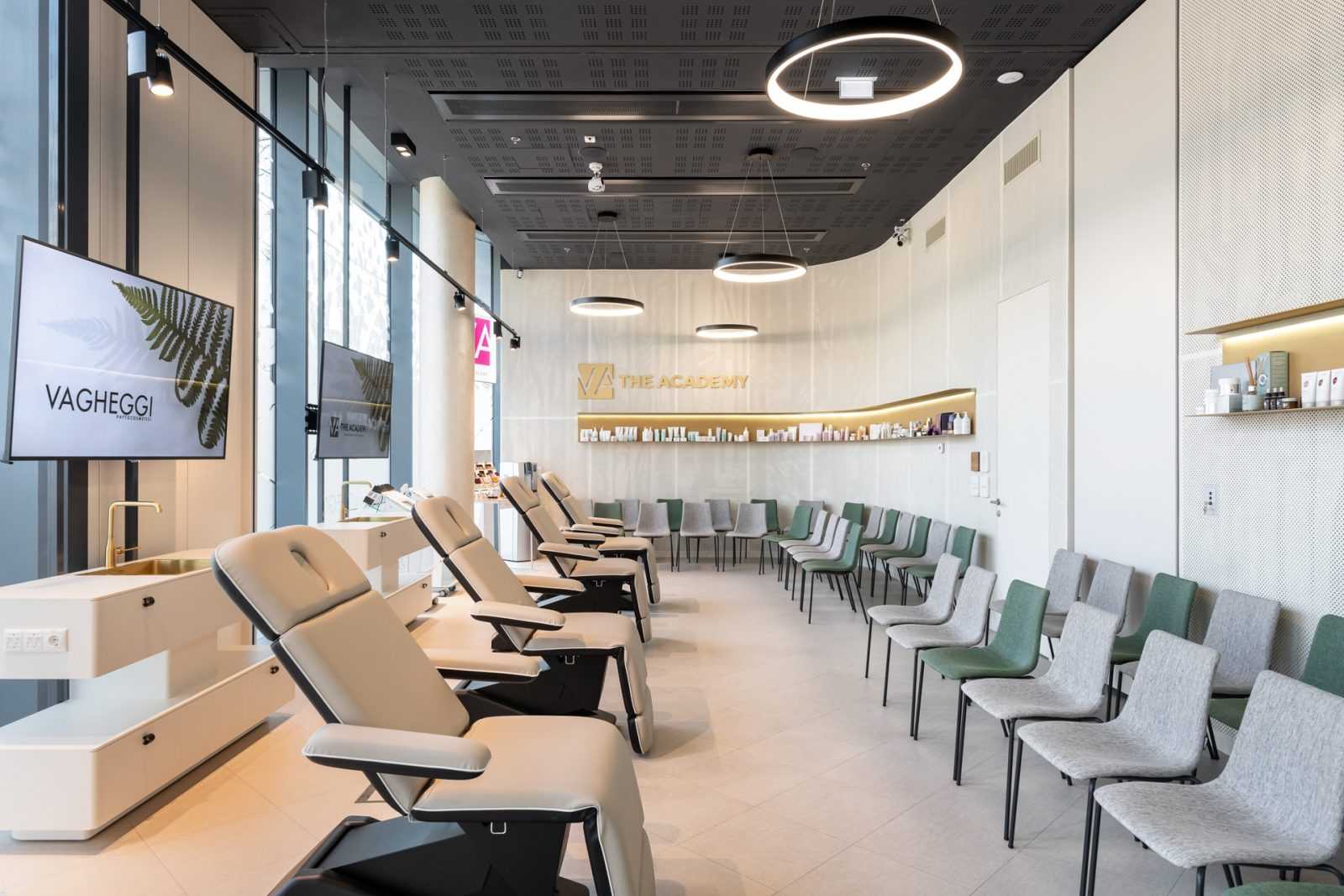 Modern beauty academy interior with treatment chairs and Vagheggi branding.