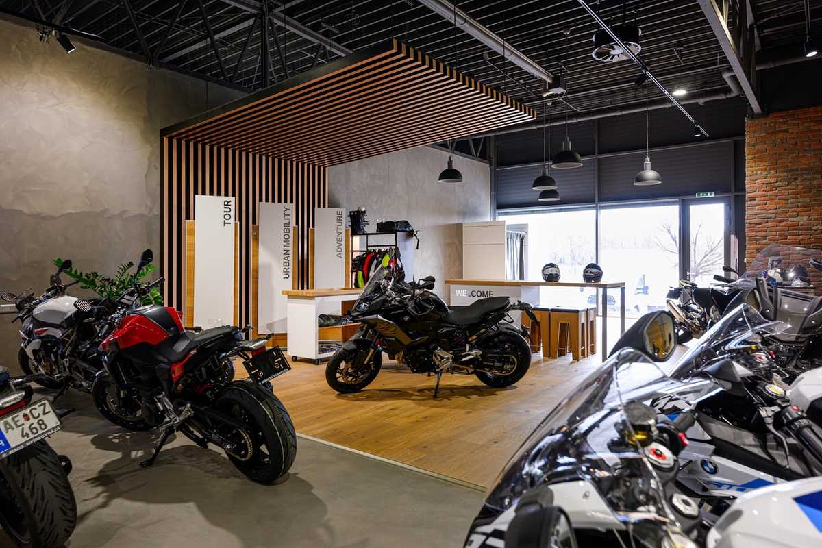 Modern motorcycle showroom with various bikes on display.