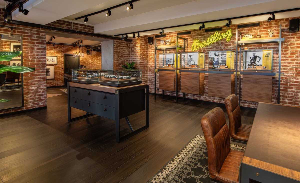 Luxury Breitling watch store interior with brick walls and display cases.
