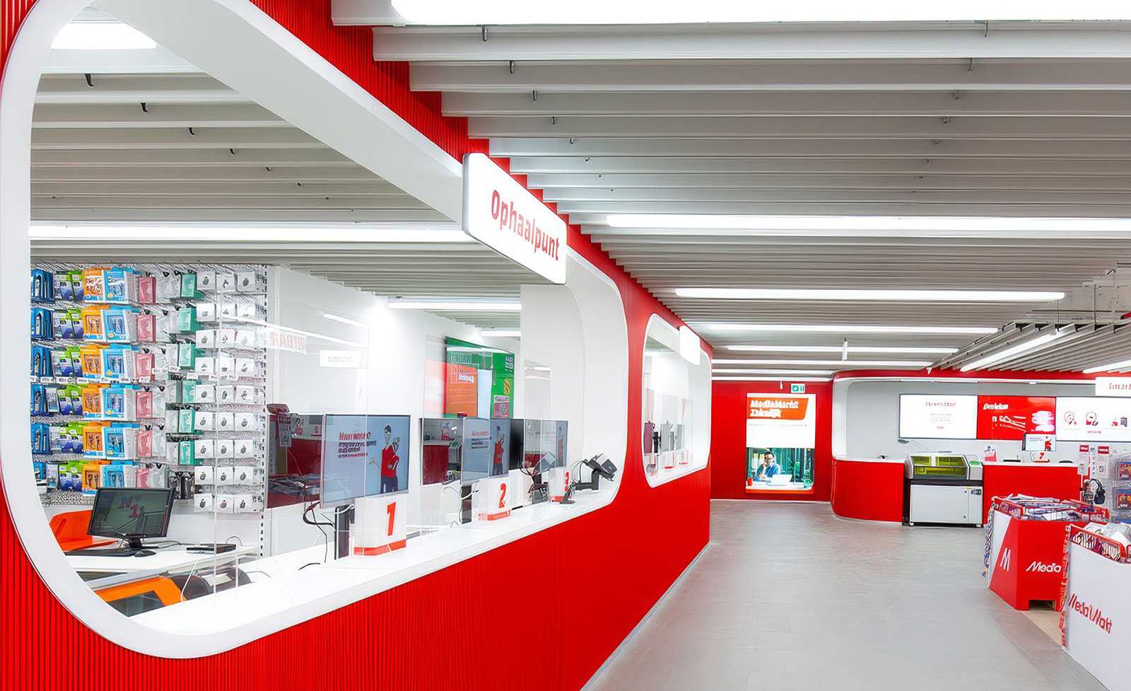 Modern red and white MediaMarkt store interior with pickup counter and product displays.