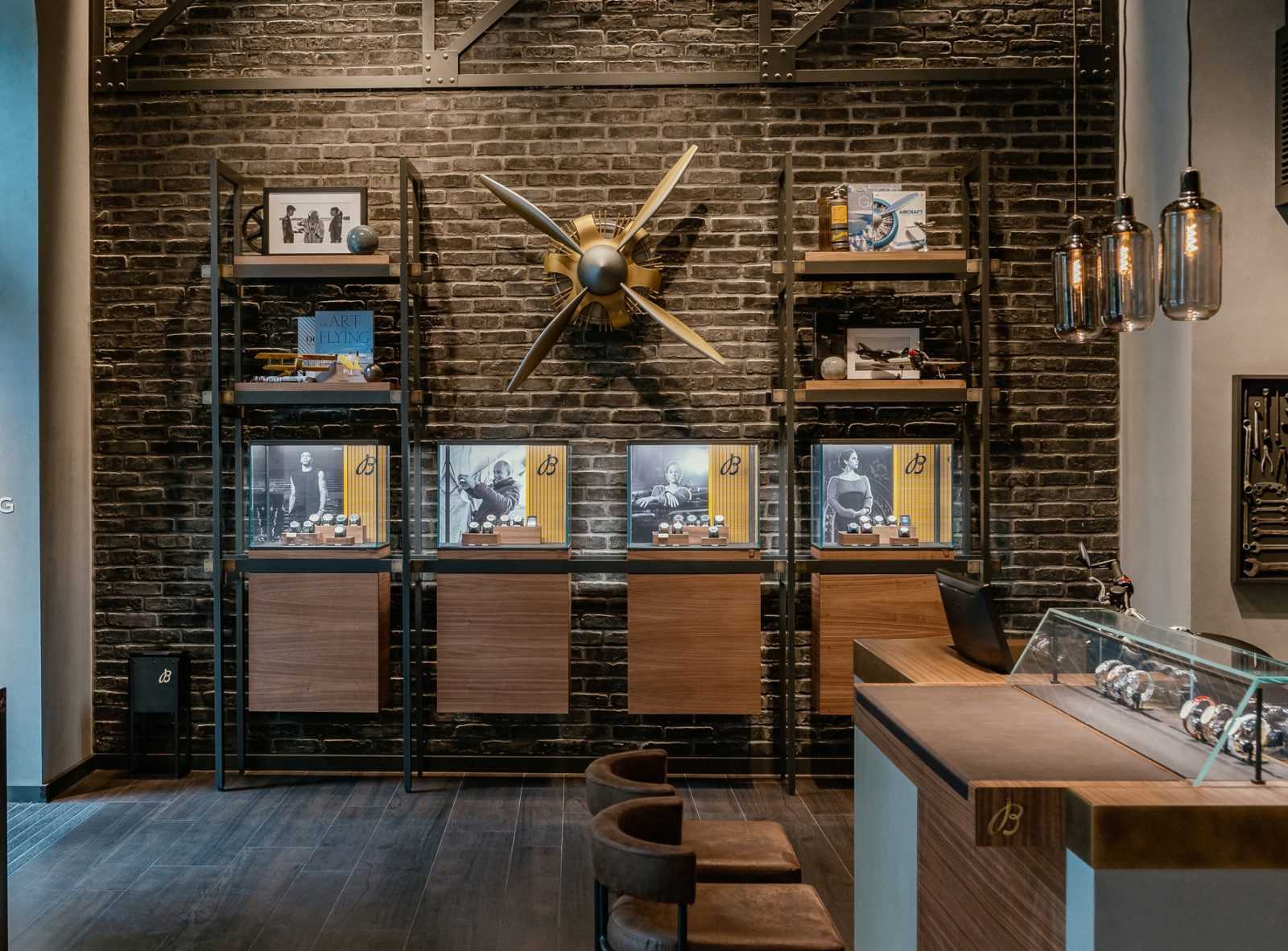 Luxury watch display in Megaholz boutique with brick wall and propeller decor.