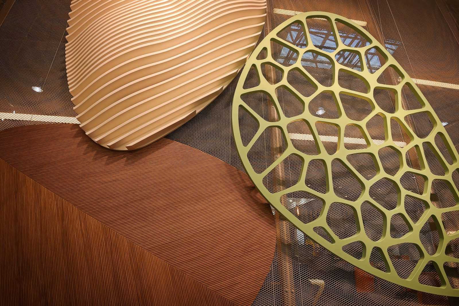 Modern wooden architectural elements with wave and lattice patterns.