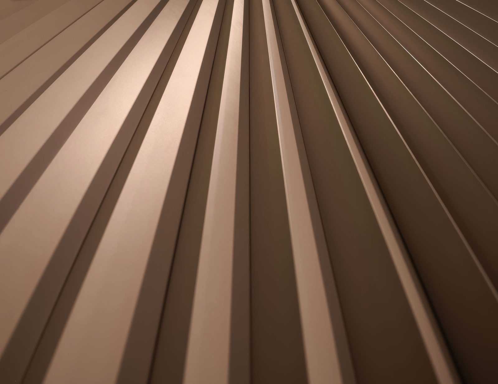 Close-up of brown wooden slats with light and shadow patterns.