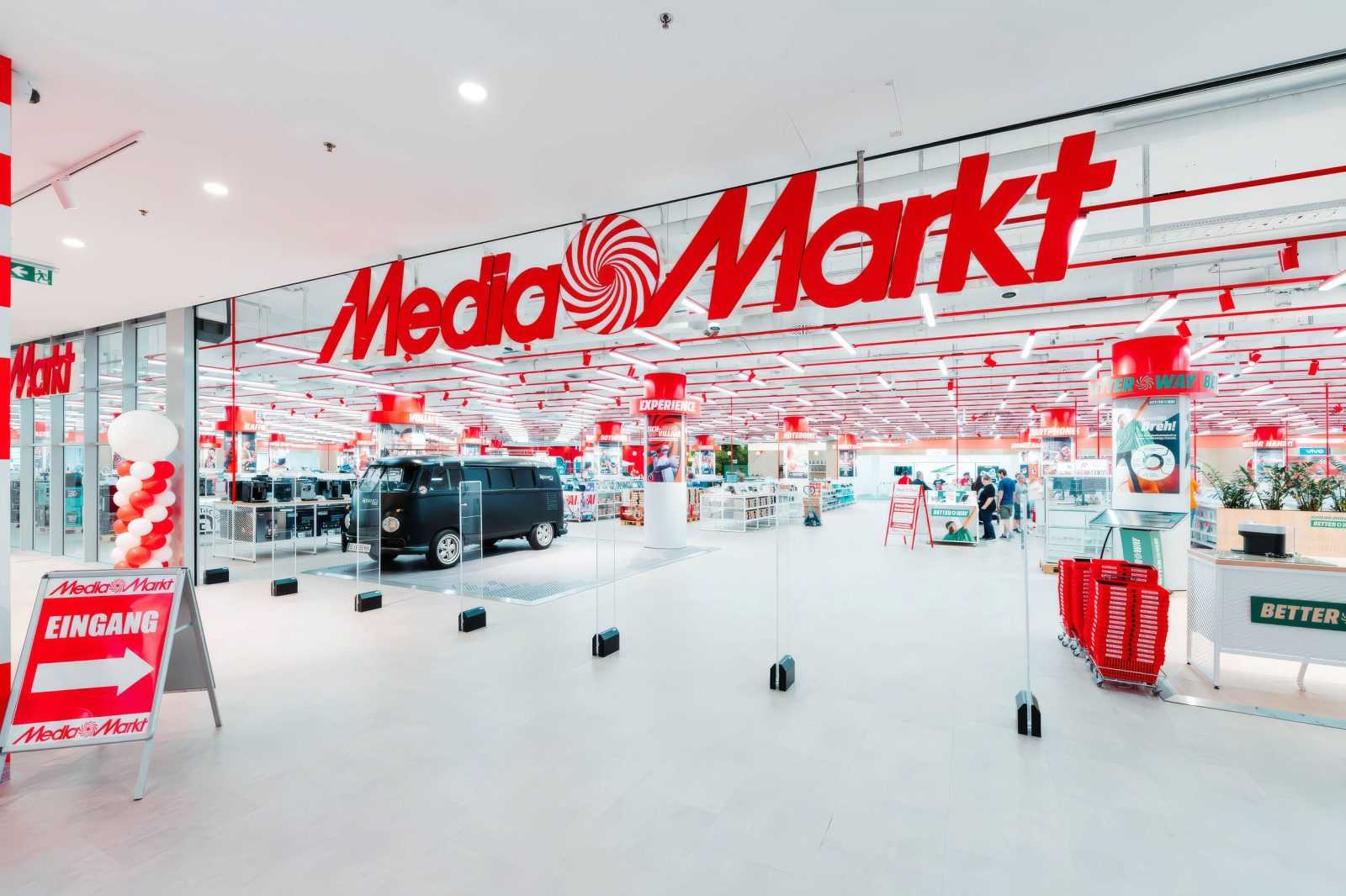 Media Markt store interior with red branding and customer displays.