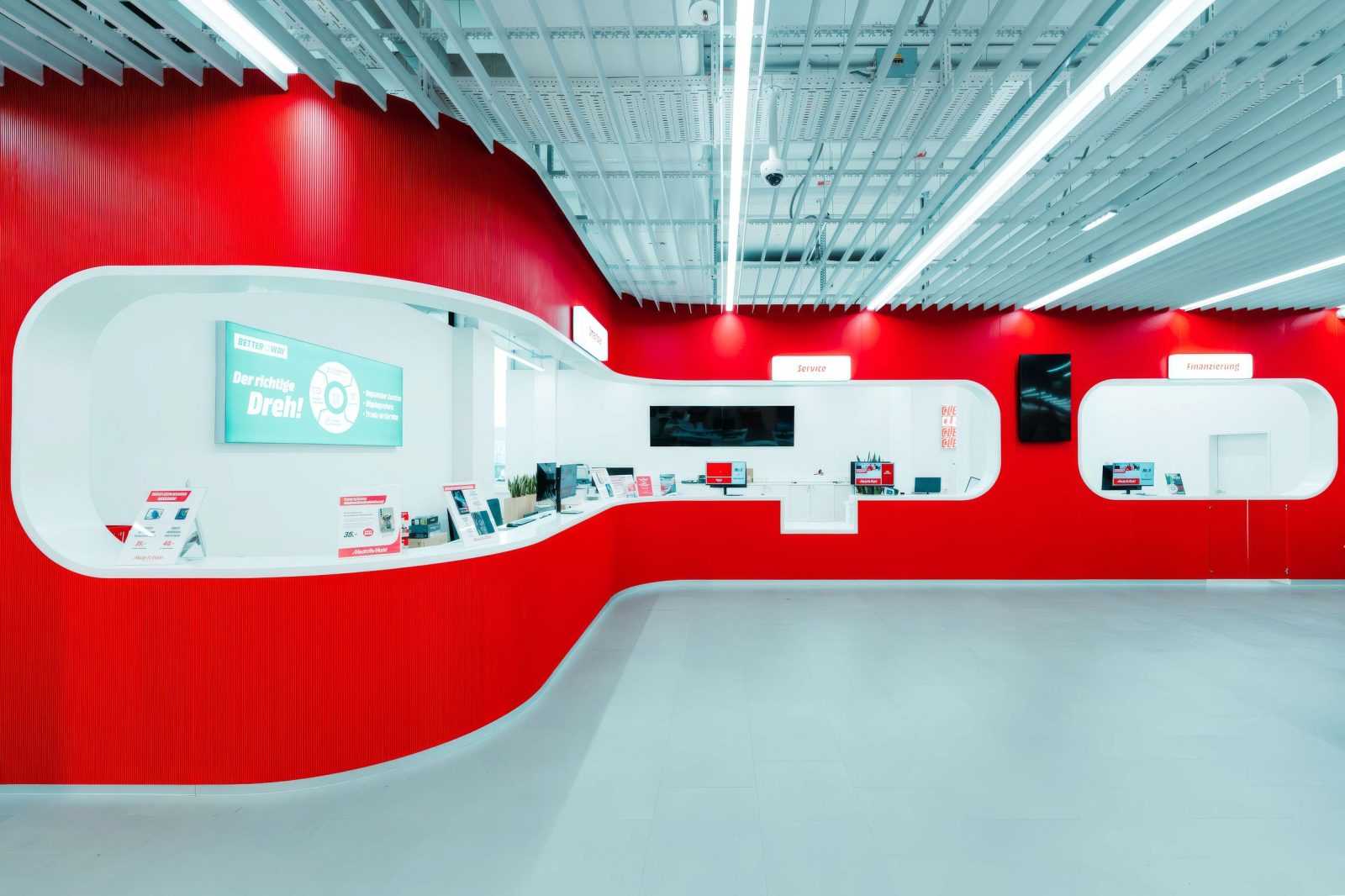 Modern red and white Megaholz store interior with service counters.