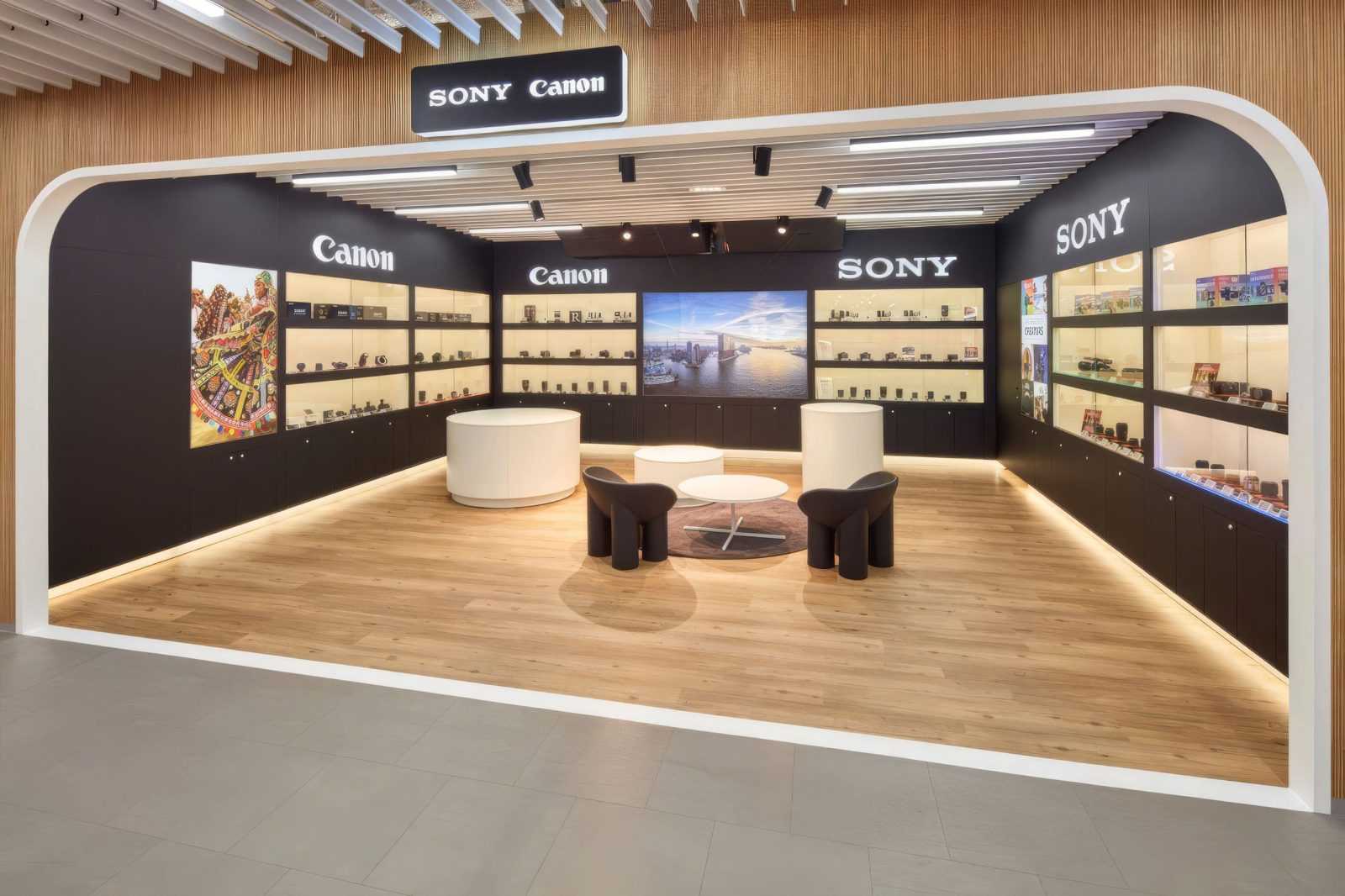 Modern Sony and Canon camera store interior with wooden floors and display shelves.
