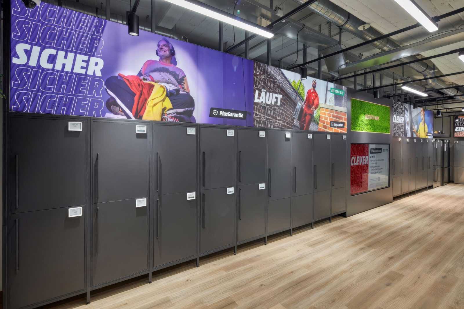 Megaholz store interior with lockers and promotional banners.