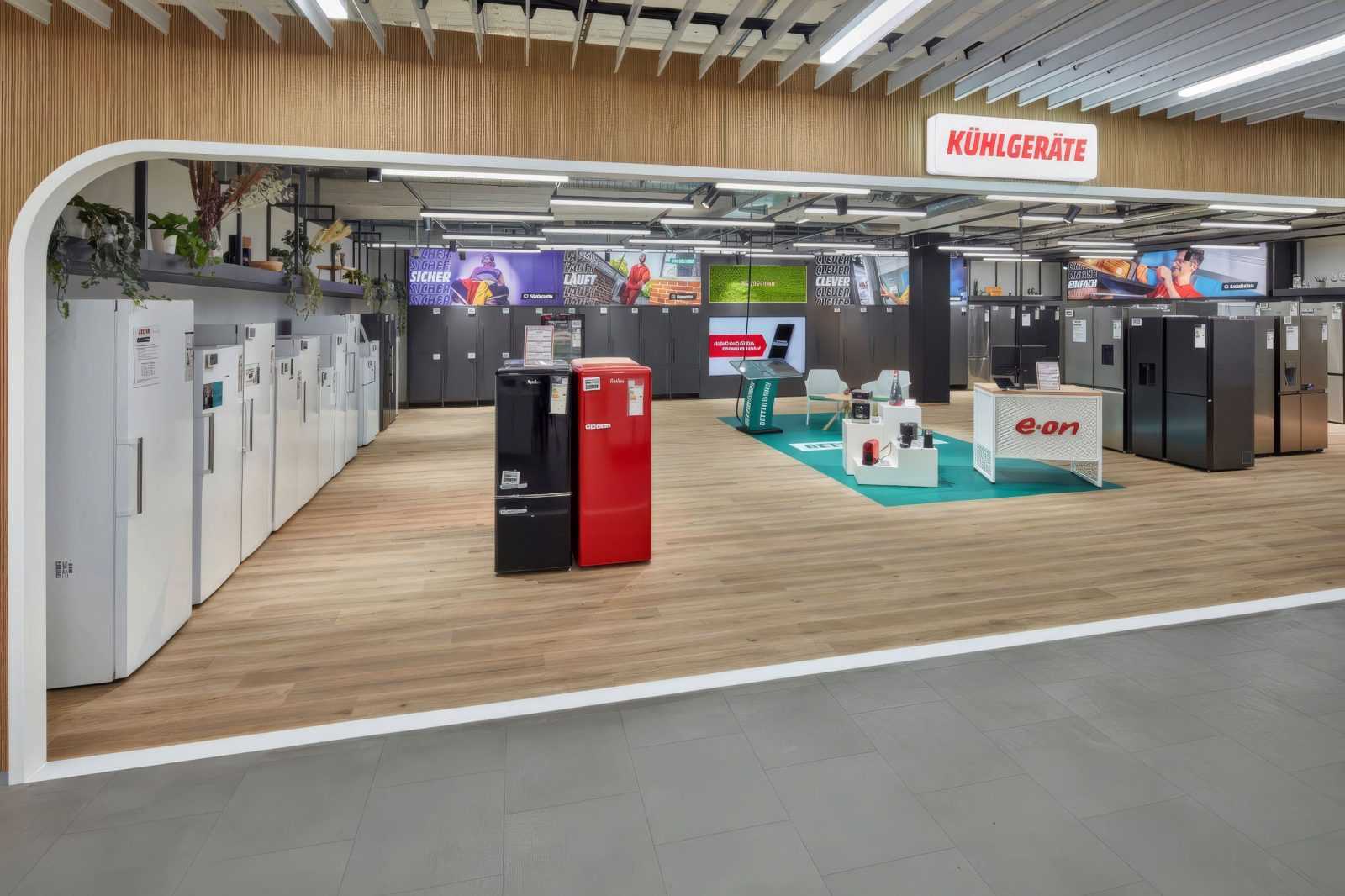 Modern refrigerator section at Megaholz store with white, black, and red models.