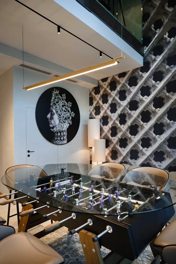 Modern foosball table in stylish interior with artistic wall decor.