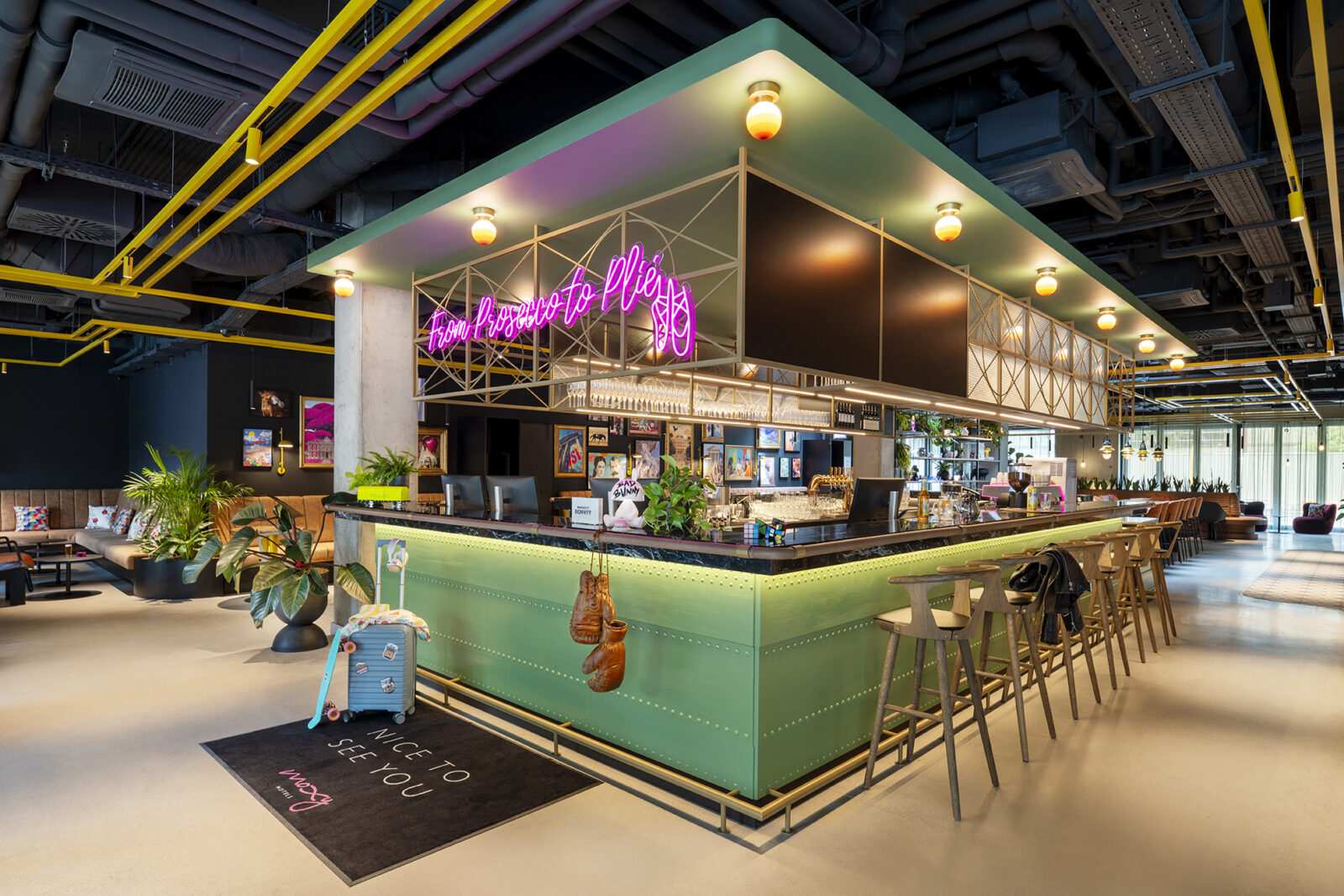 Modern bar with neon sign and green counter at Megaholz.